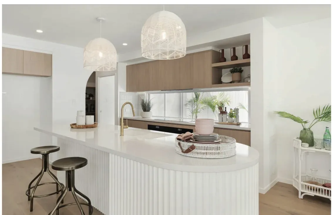 Styled kitchen with white island bench, timber cabinetry and woven pendant lights