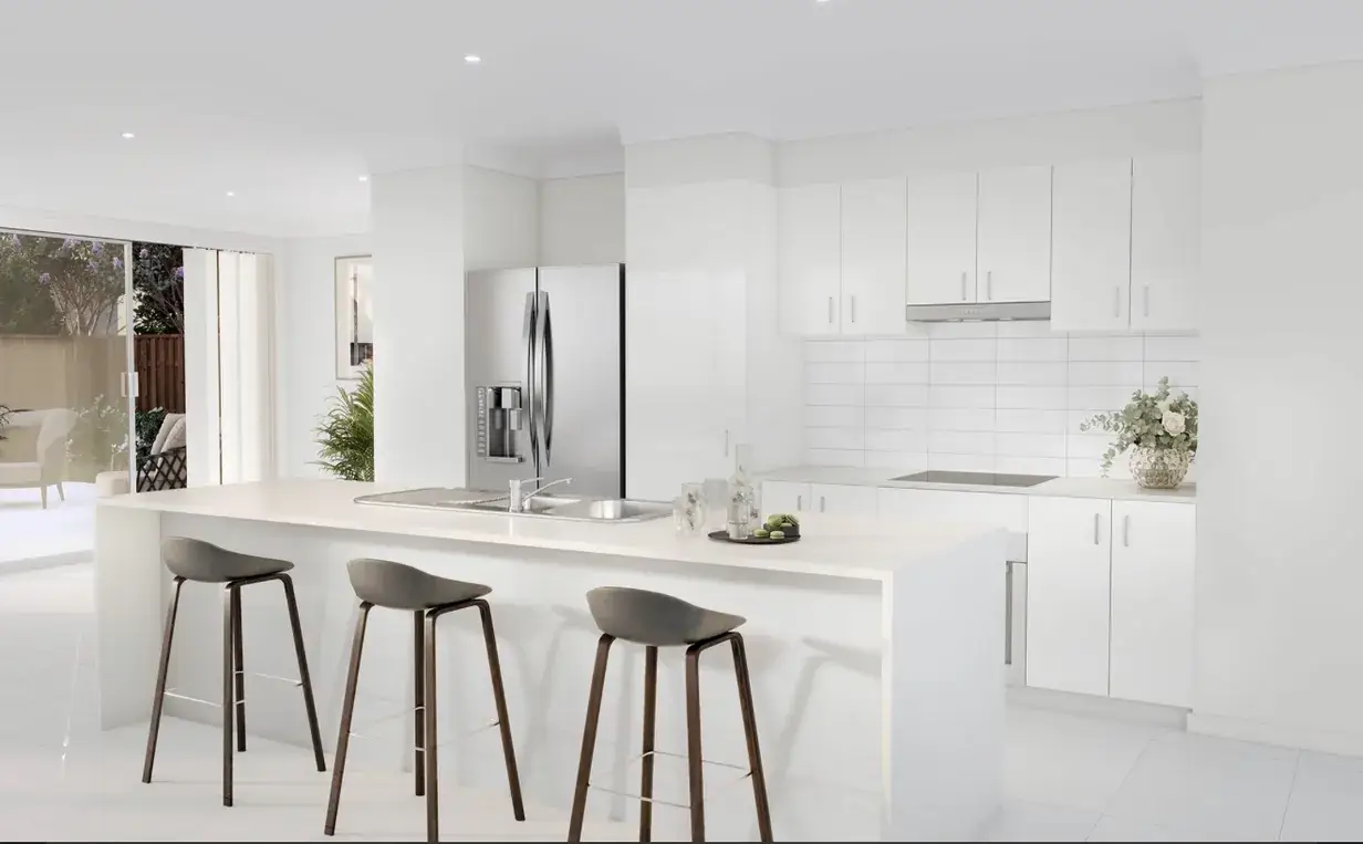 All-white kitchen with waterfall island, stainless fridge and bar stools