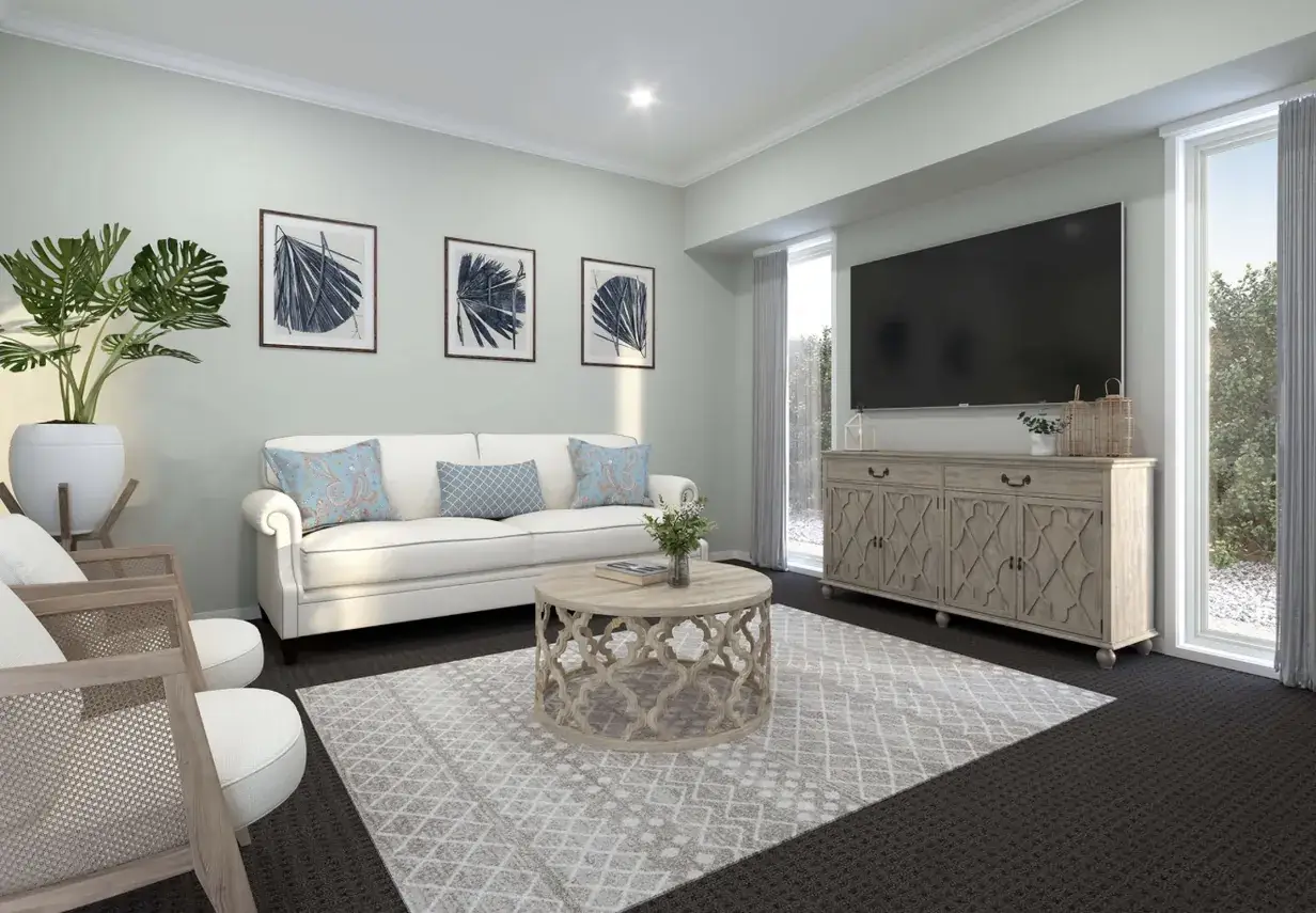 White sofa, dusty blue cushions and rattan armchairs in a coastal-style living room